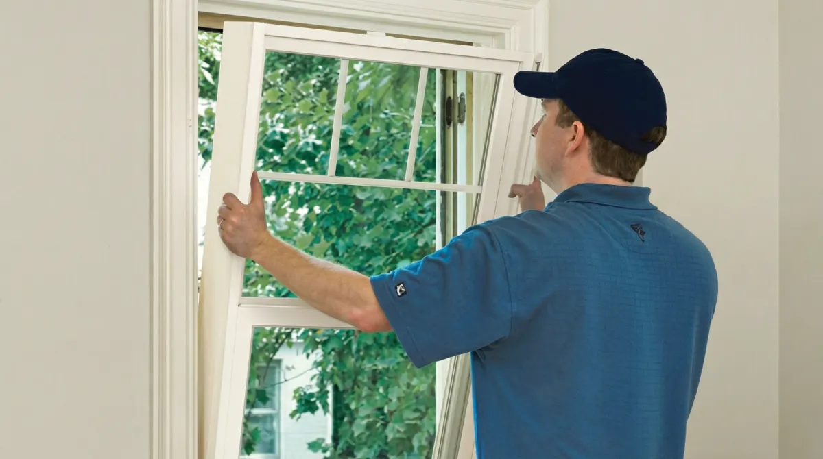 Professional contractors performing a residential window insulation and replacement service in Arvada, CO
